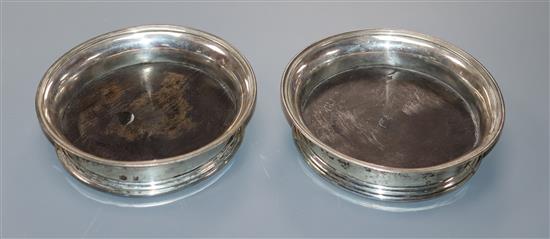 A pair of 19th century Dutch 833 white metal coasters, with wooden bases, 13.8cm.